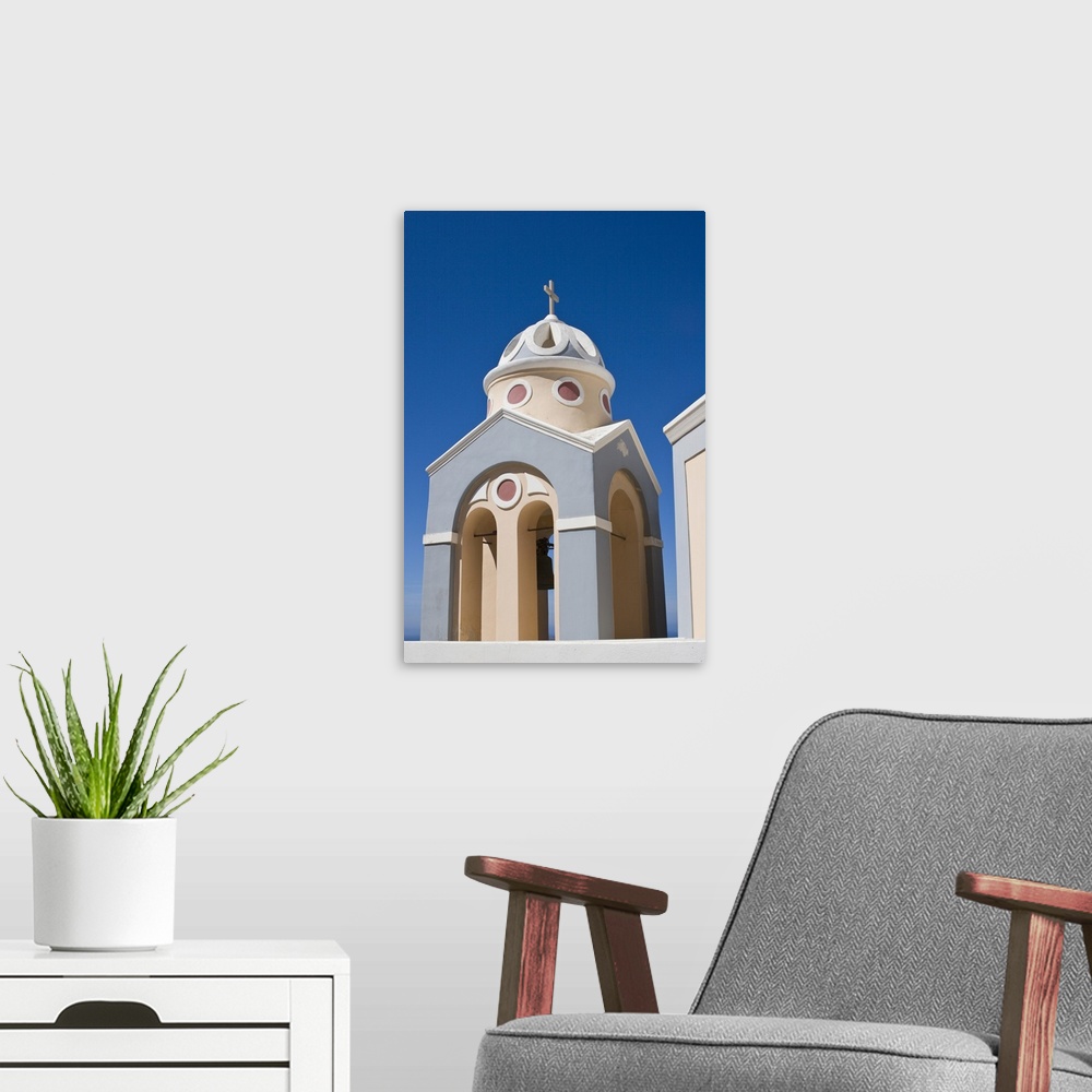 A modern room featuring Europe, Greece, Santorini. Peach and grey church bell tower against clear blue sky.