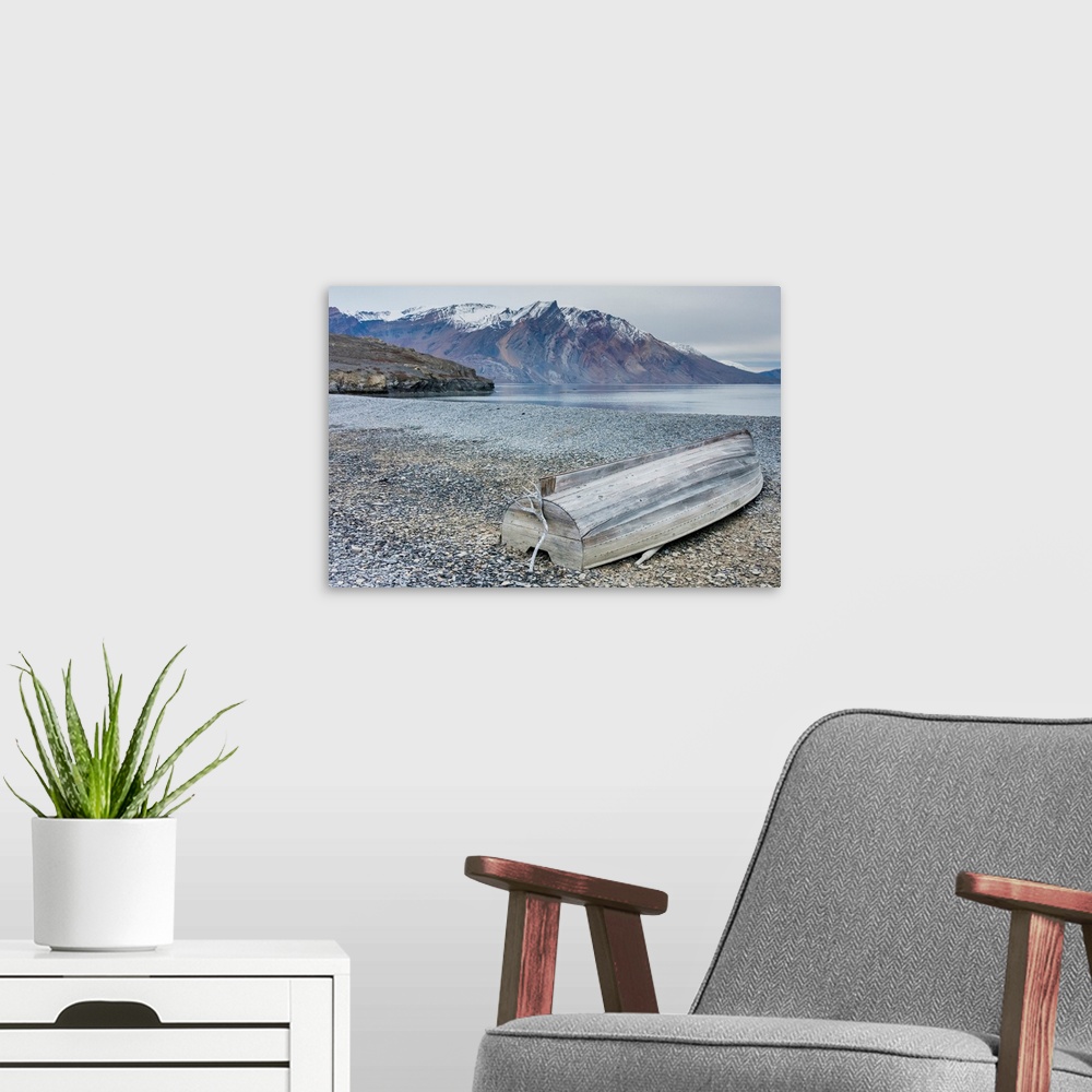 A modern room featuring Greenland. Northeast Greenland National Park, Kong Oscar Fjord. Ella Island. Weathered boat on th...