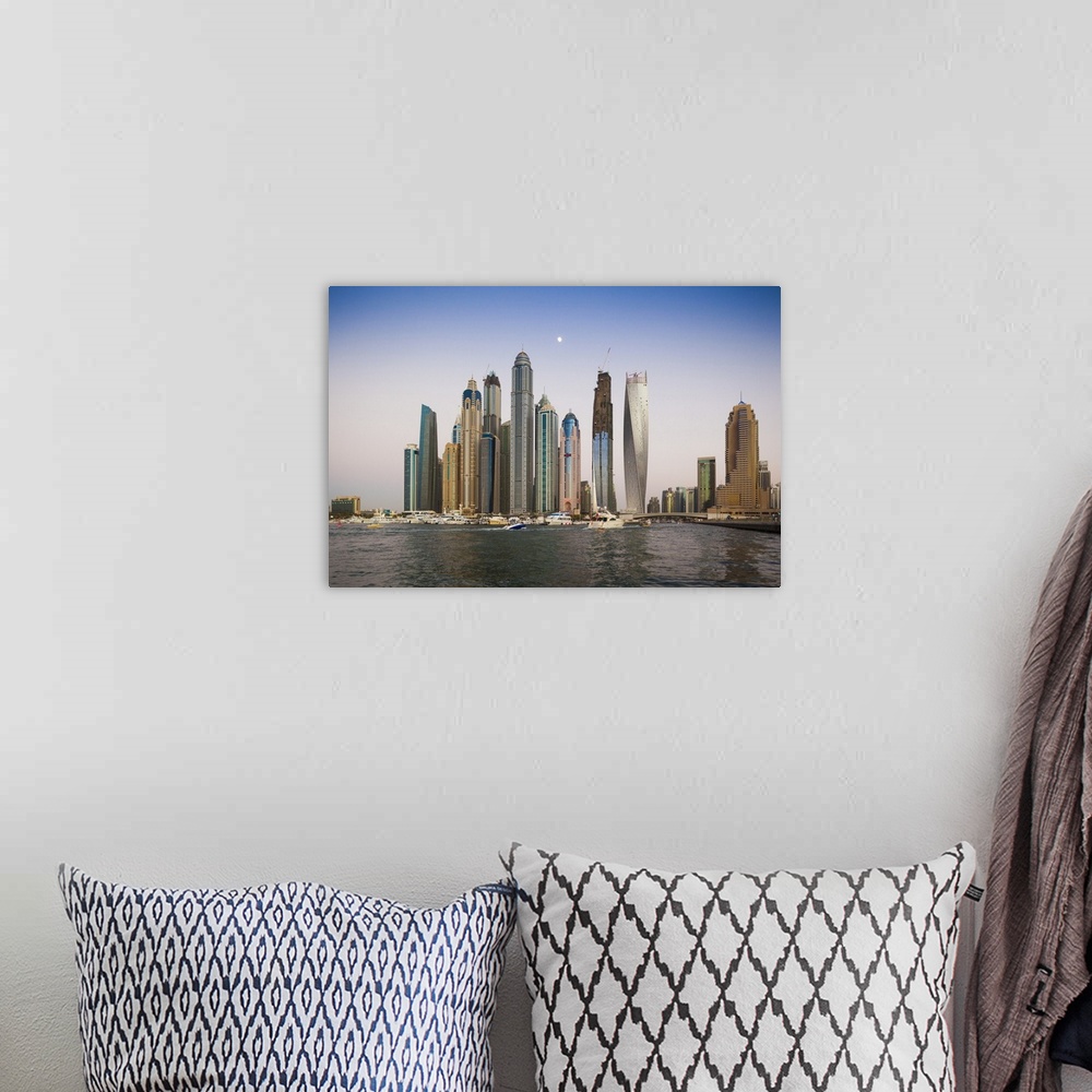 A bohemian room featuring UAE, Dubai, Dubai Marina, high rise buildings including the twisted Cayan Tower, with moonrise, dusk