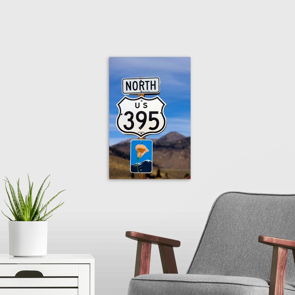 A modern room featuring An upward view of a Highway 395 North sign post including a California Scenic Highway sign.