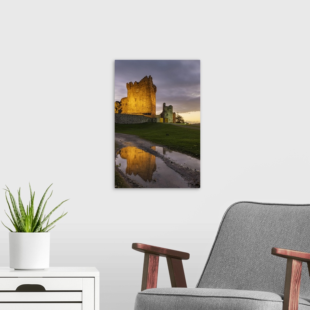 A modern room featuring Historic Ross Castle at dusk in Killarney National Park, Ireland.