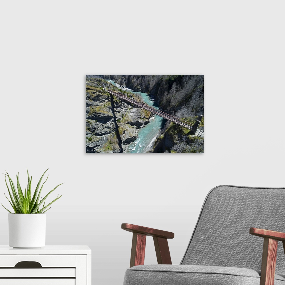 A modern room featuring Historic skippers suspension bridge (1901), above shotover river, skippers canyon, Queenstown, So...