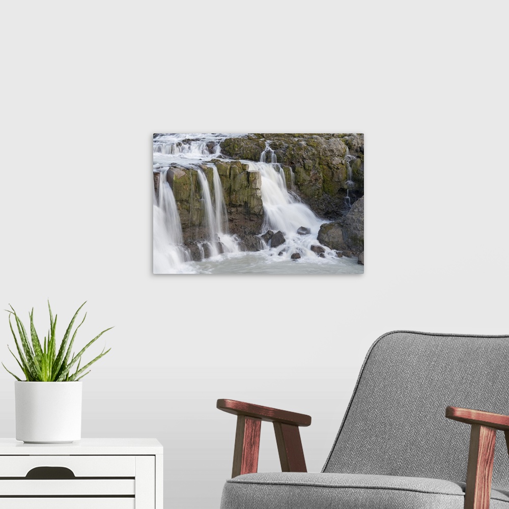 A modern room featuring Iceland, Gygjarfoss Waterfall Flows Through A Rather Barren Landscape