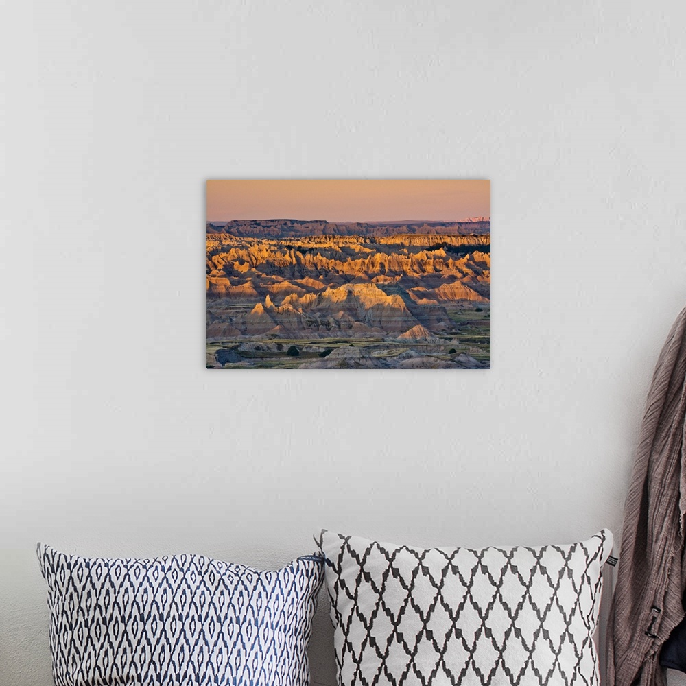 A bohemian room featuring illuminated buttes, sunrise,  Pinnacles Viewpoint, Badlands National Park, South Dakota, USA