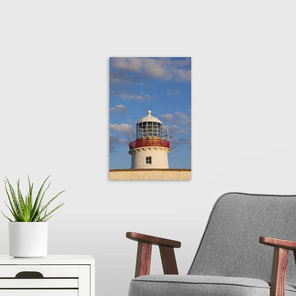 A modern room featuring Ireland, County Donegal, St. John's Point, St. John's Point Lighthouse, dusk.