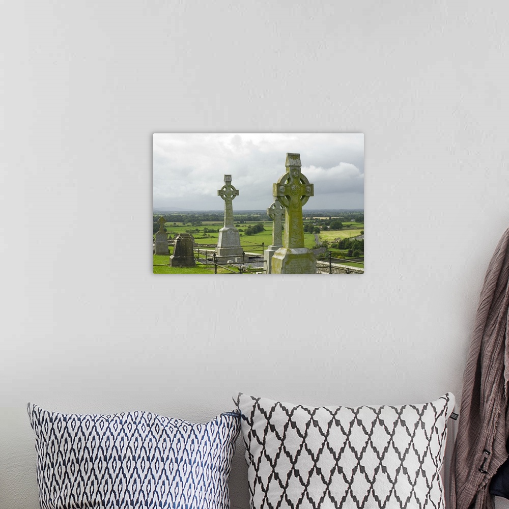 A bohemian room featuring IRELAND, Tipperary, Cashel. View of celtic cross and farmland beyond, Rock of Cashel