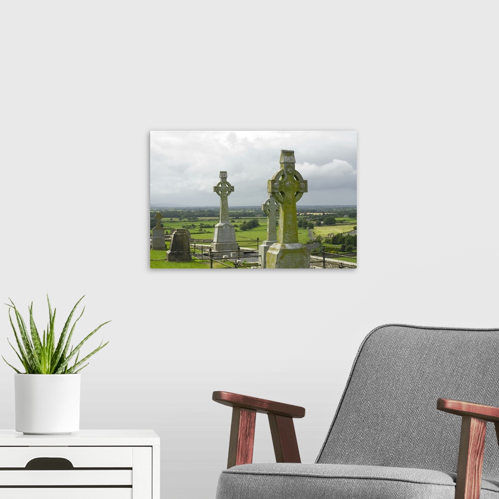 A modern room featuring IRELAND, Tipperary, Cashel. View of celtic cross and farmland beyond, Rock of Cashel