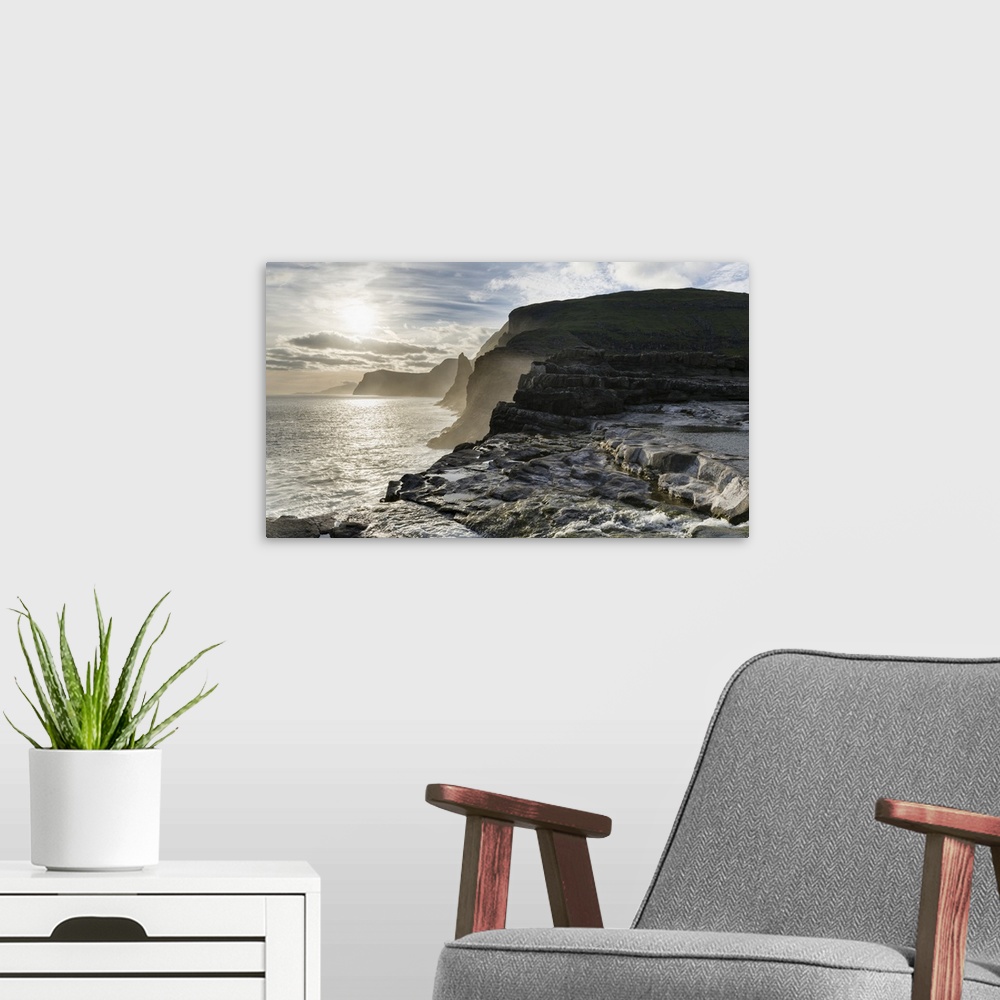 A modern room featuring The west coast near Traelanipa with waterfall Bosdalafossur at sunset. The island Vagar, part of ...