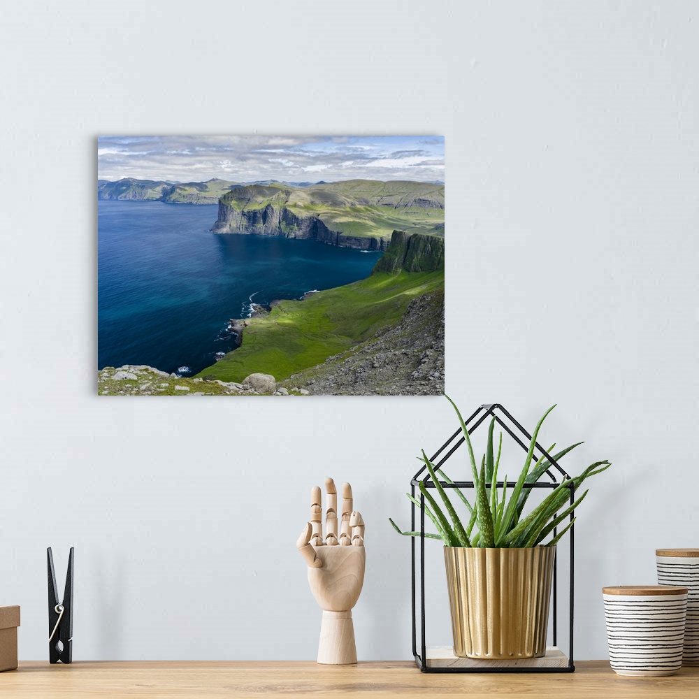 A bohemian room featuring View over settlement Vikar towards Streymoy. Mountains of the island Vagar, part of the Faroe Isl...