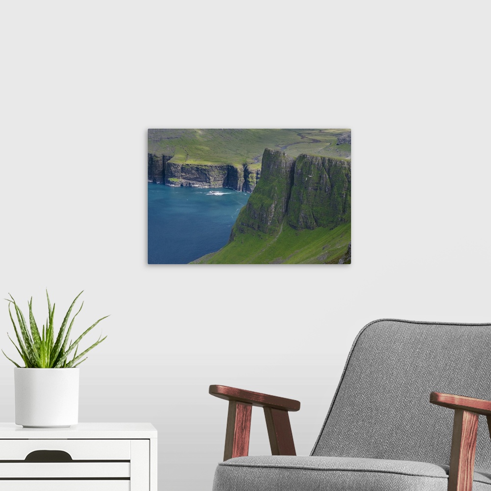 A modern room featuring The mountains of Vagar, part of the Faroe Islands. Europe, Northern Europe, Denmark, Faroe Islands.