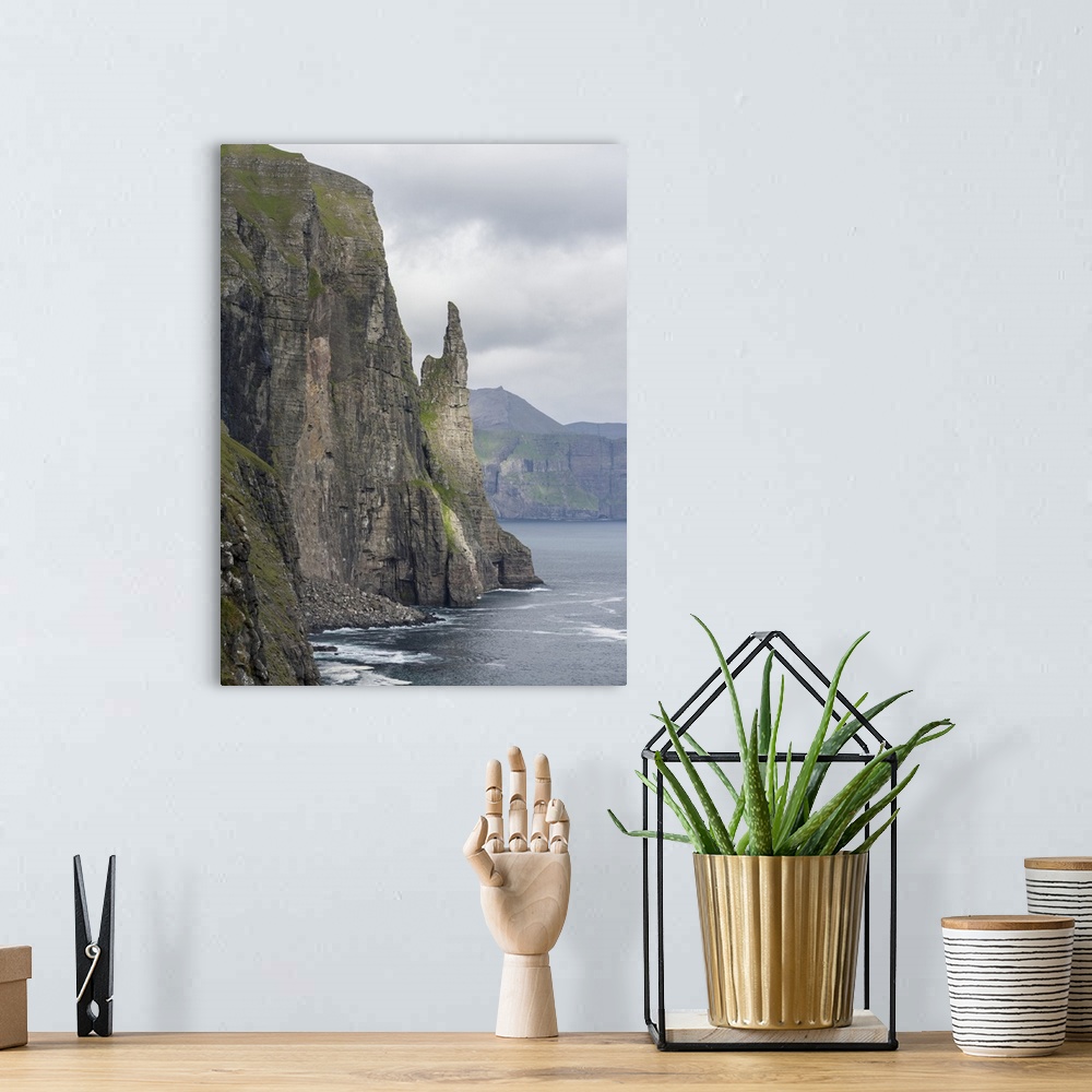 A bohemian room featuring The landmark Trollkonufingur in the cliffs of the island of Vagar, part of the Faroe Islands. Eur...