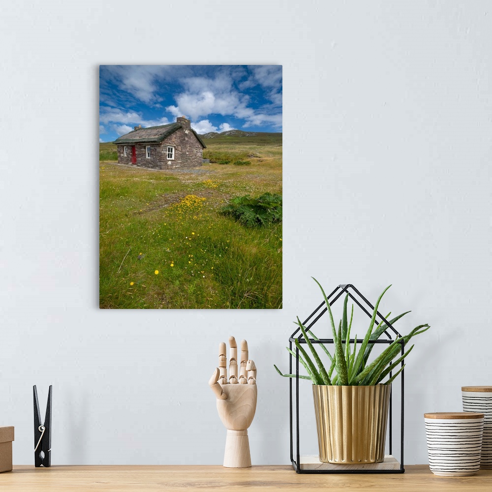 A bohemian room featuring Isolated stone cottage weathers storms along the Wild Atlantic Way, County Mayo, Ireland.