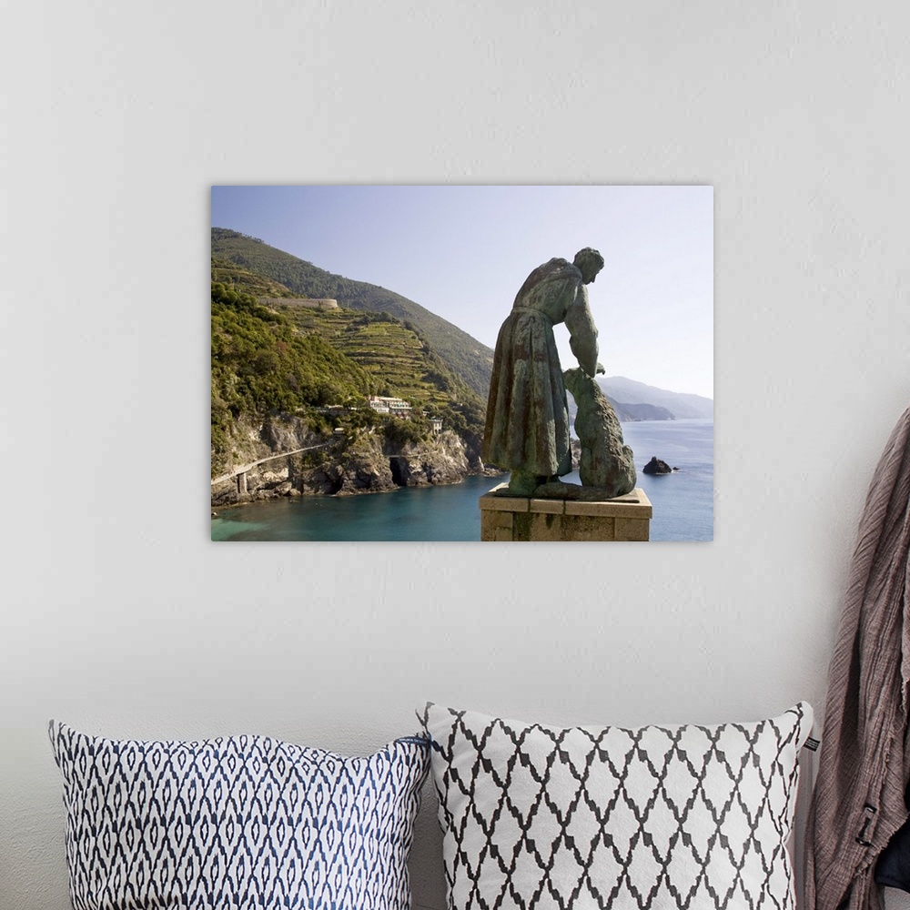 A bohemian room featuring Europe, Italy, Cinque Terre, Monterosso. A statue of St. Francis of Assisi petting a dog and look...