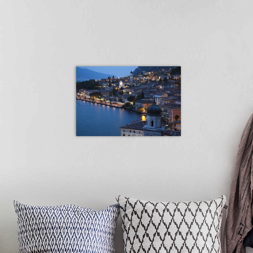 A bohemian room featuring ITALY, Brescia Province, Limone sul Garda. Aerial town view, dusk.
