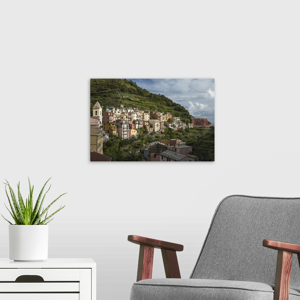 A modern room featuring Italy, Cinque Terre, Manarola. View of housing amidst the steep hillsides.