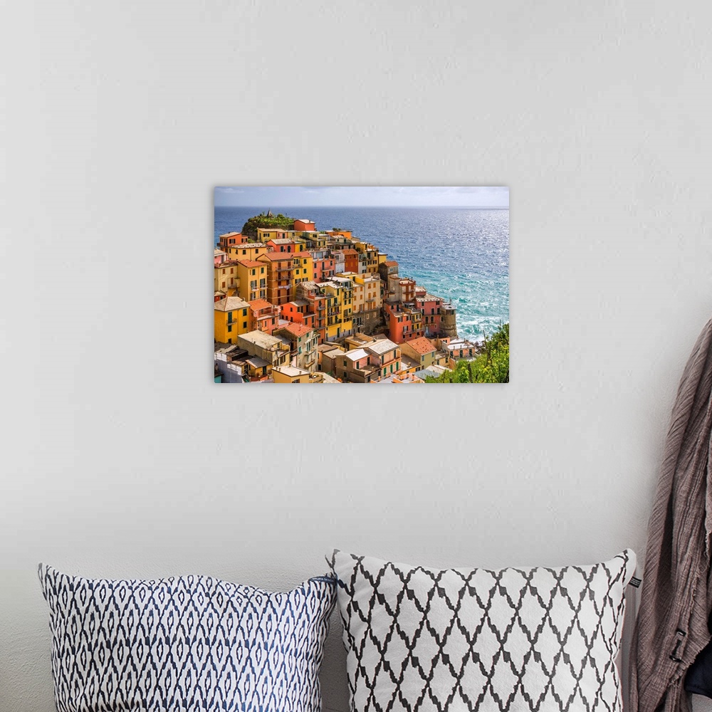 A bohemian room featuring Italy, Manarola. Overview of coastal village and sea. Credit: Jim Nilsen