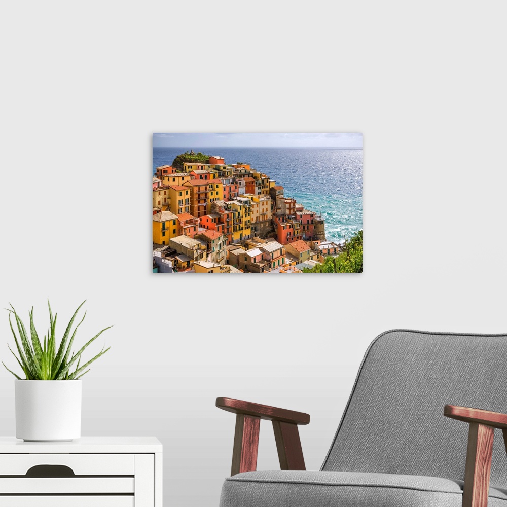 A modern room featuring Italy, Manarola. Overview of coastal village and sea. Credit: Jim Nilsen