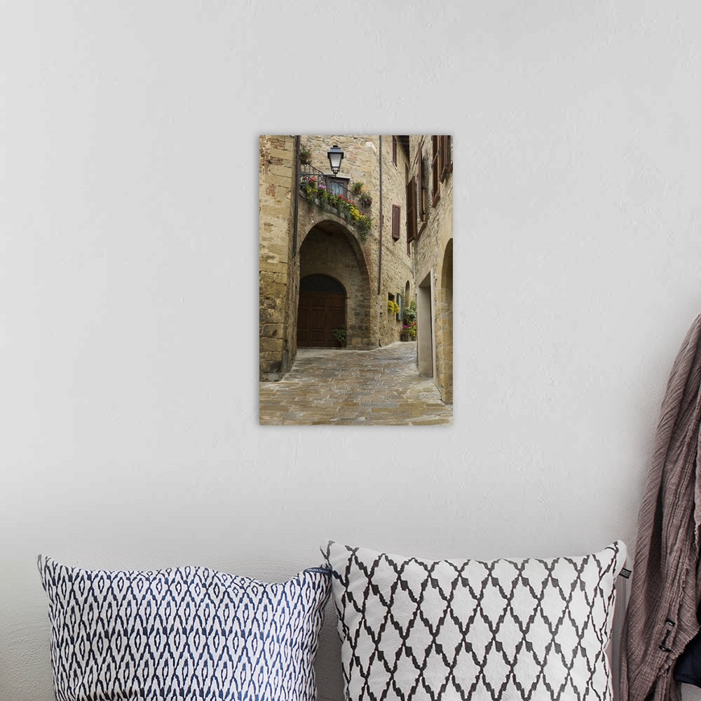 A bohemian room featuring Italy, Montichiello. Houses along a lane in a medieval village.