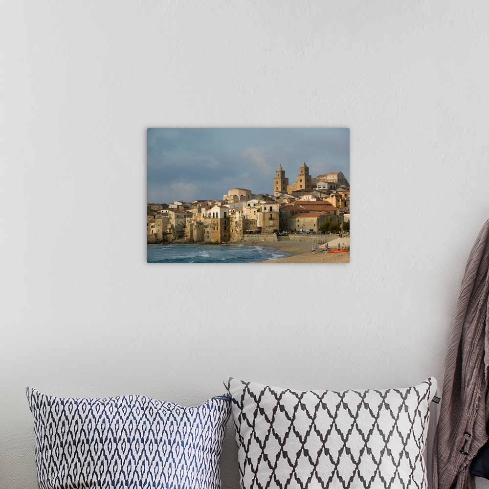 A bohemian room featuring ITALY-Sicily-CEFALU:.Town View with Duomo from Beach / Sunset... Walter Bibikow 2005
