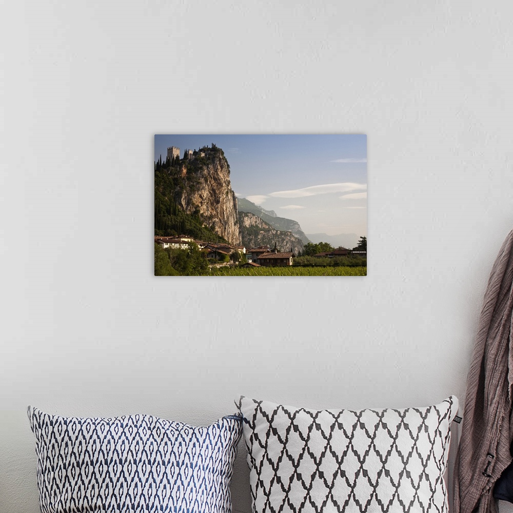A bohemian room featuring Italy, Trento Province, Arco. Mountaintop Castello di Arco, view from Sarca River, morning.