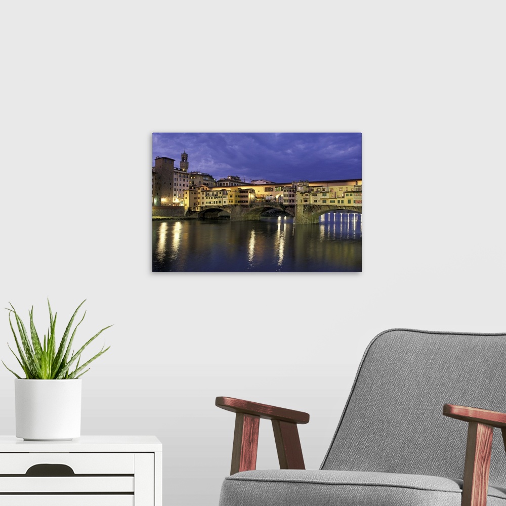 A modern room featuring Europe, Italy, Tuscany, Florence. Evening view of Ponte Vecchio from Arno River