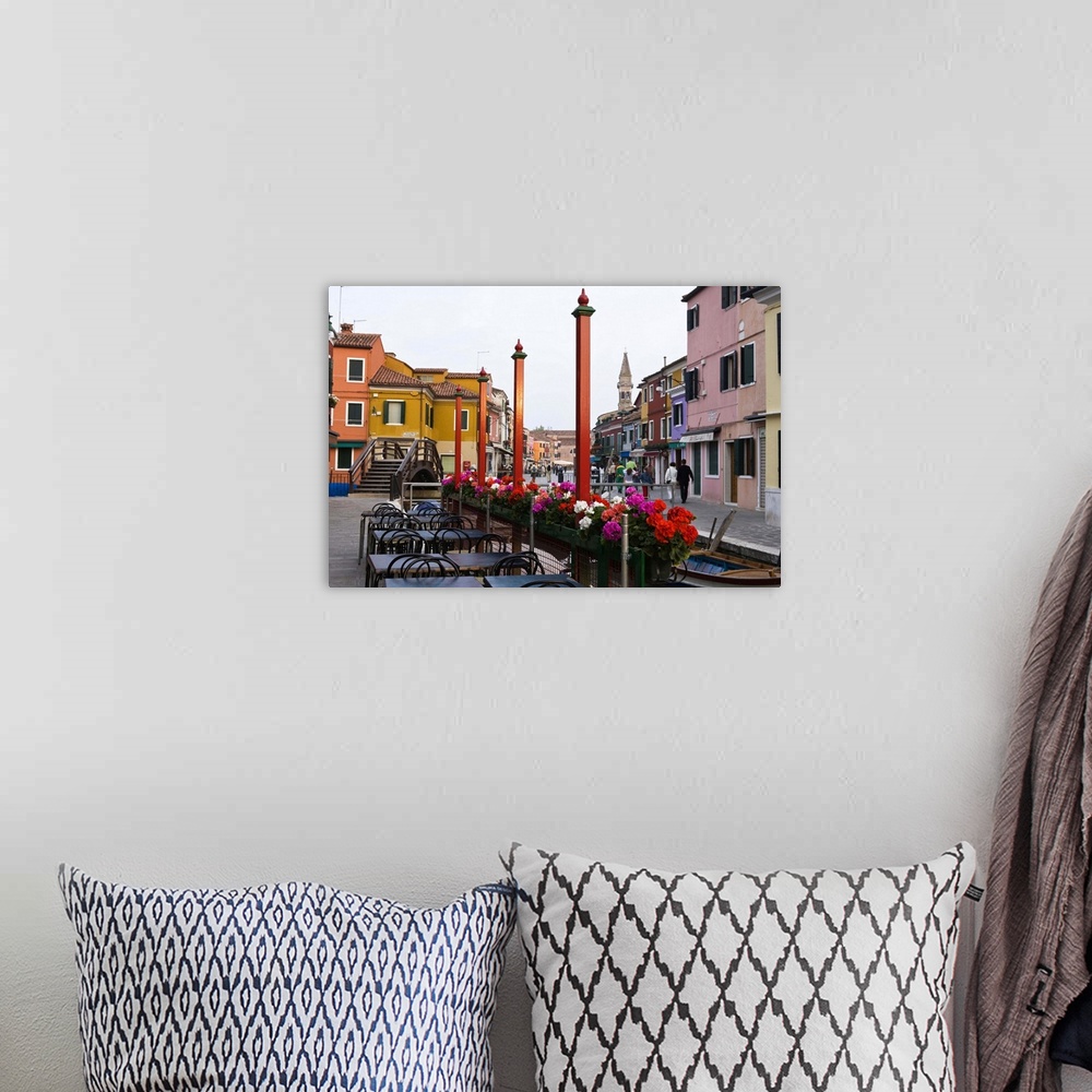 A bohemian room featuring Italy, Venice, Burano. Cafe tables along the canal.