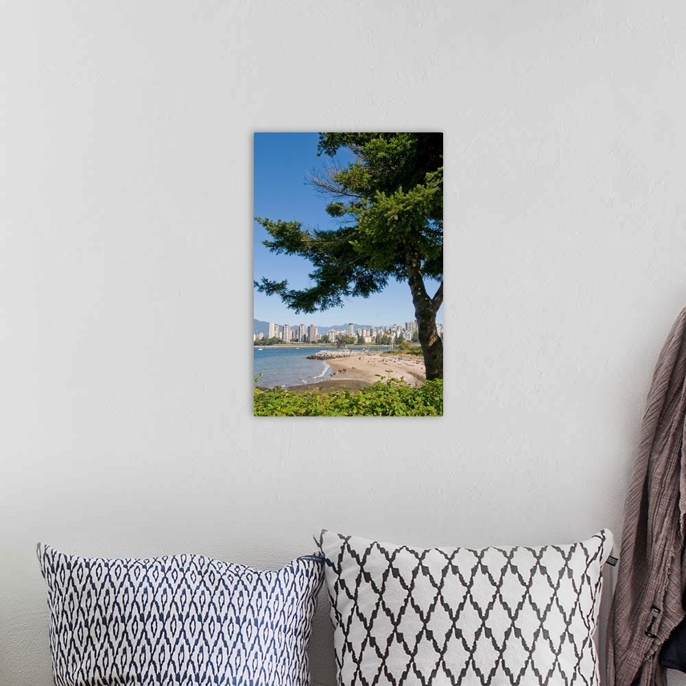 A bohemian room featuring Kitsilano Beach park overlooking English Bay and the skyline of downtown Vancouver, BC, Canada.