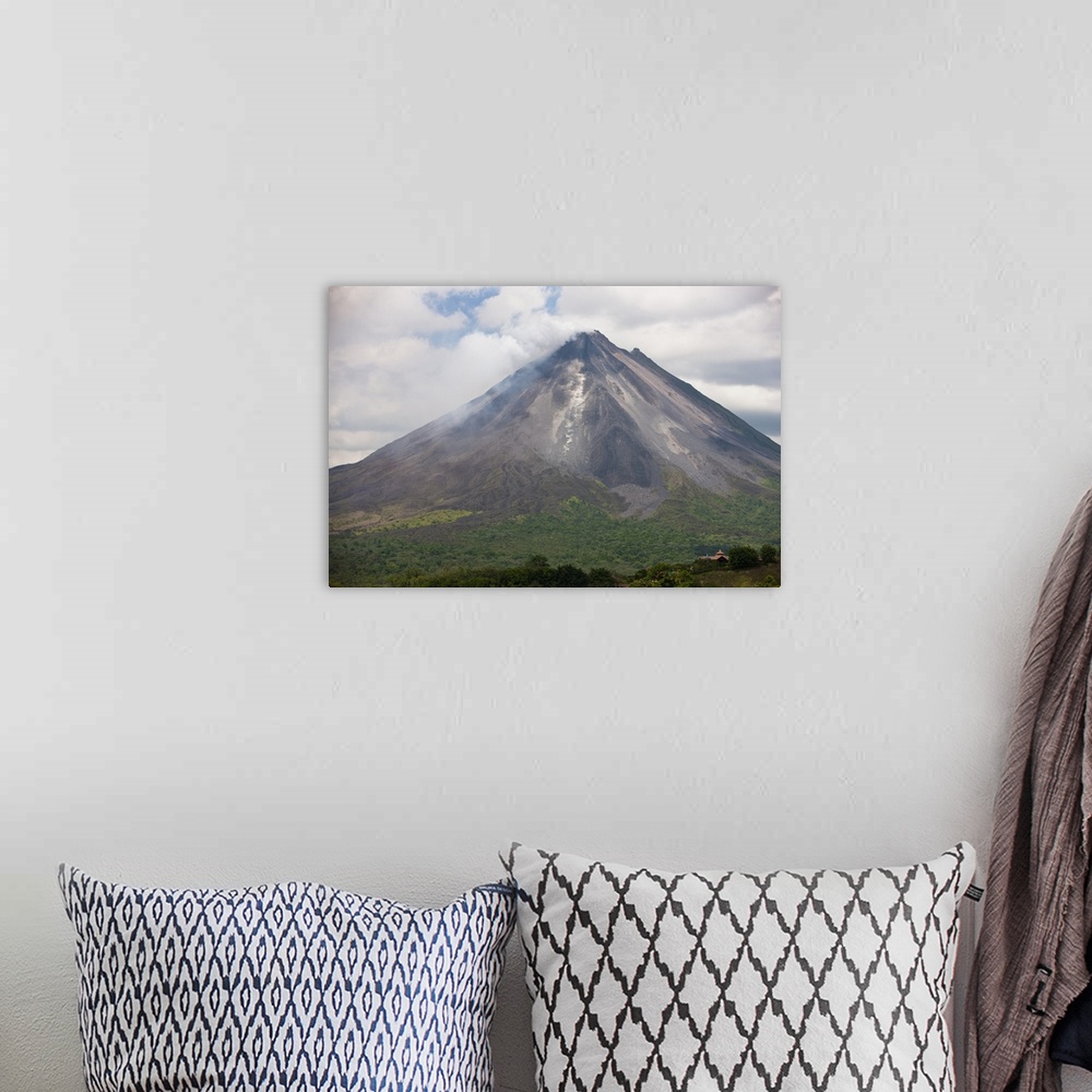 A bohemian room featuring Lava rocks are thrown from the erupting Arenal volcano to the mountainside and forest below in Ar...