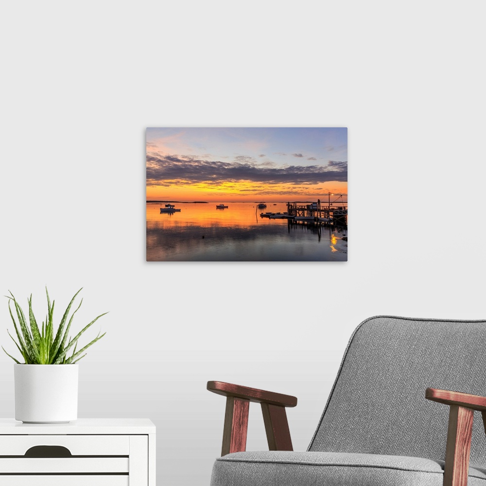 A modern room featuring Lobster boats in a harbor in South Thomaston, Maine at sunrise.