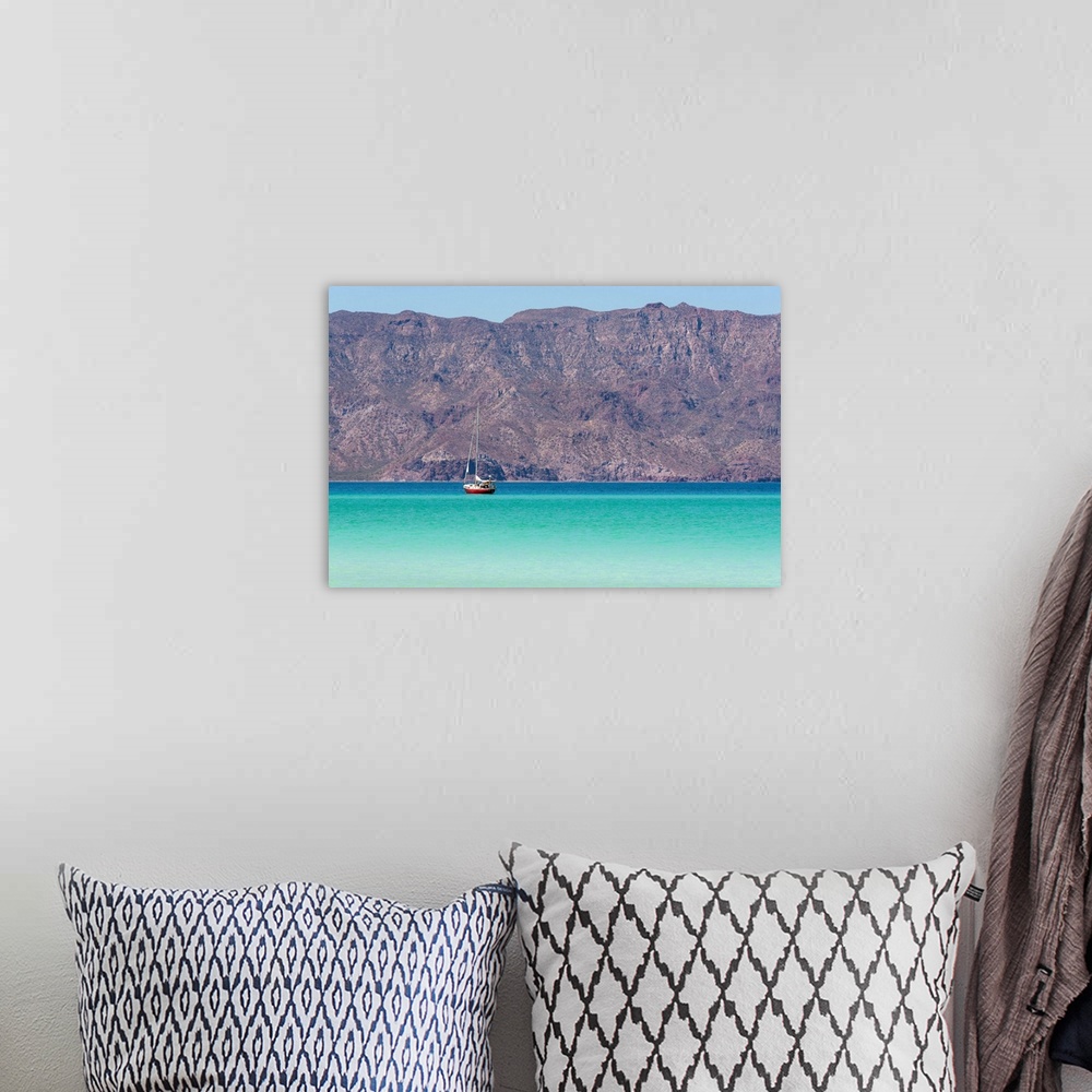 A bohemian room featuring Mexico, Baja California Sur, Sea of Cortez, Loreto Bay. Lone sailboat on flat calm water with Sie...