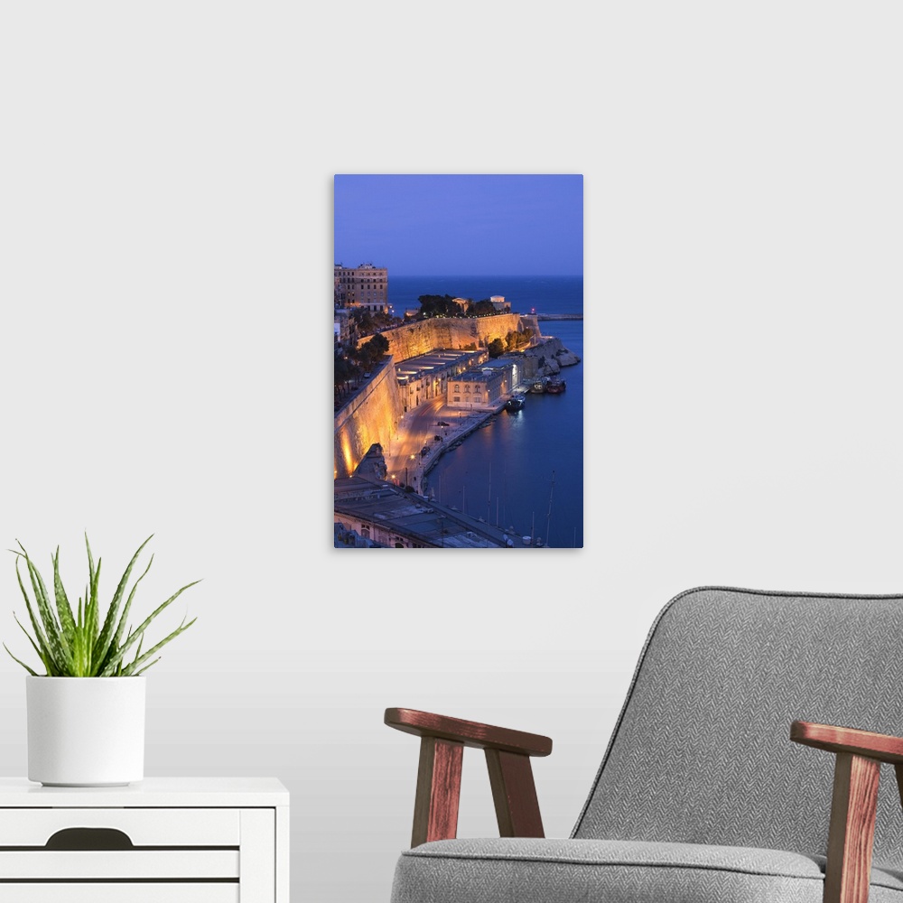 A modern room featuring Malta, Valletta, city view from Upper Barrakka Gardens, evening