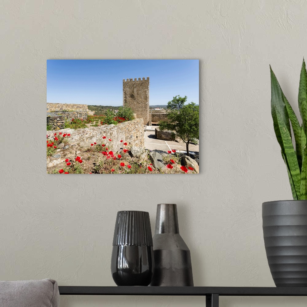 A modern room featuring The medieval castle with foudations from moorish times . Mertola on the banks of Rio Guadiana in ...