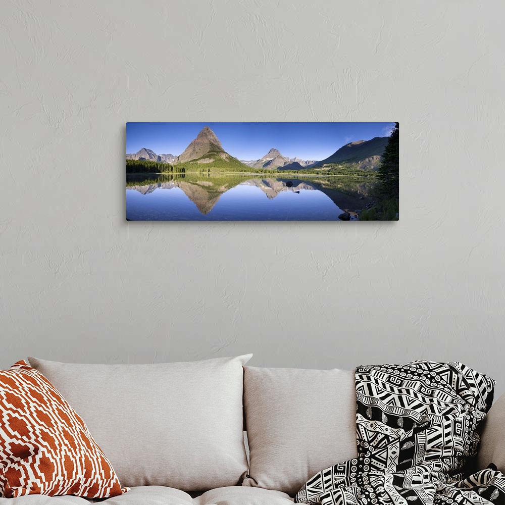 A bohemian room featuring Mountains reflected in Lake. Glacier National Park. Montana. USA.