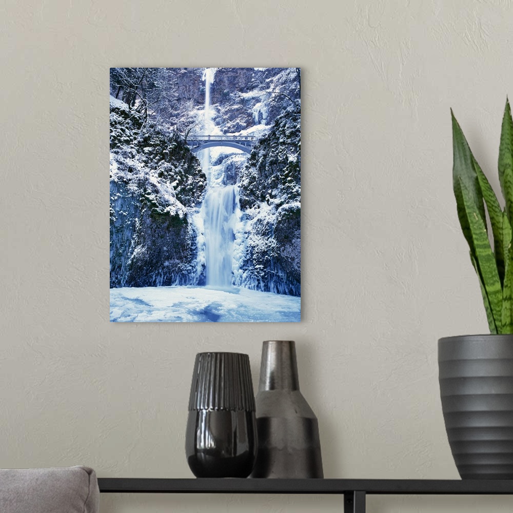 A modern room featuring Multnomah Falls with snow and ice, winter in Columbia River Gorge.