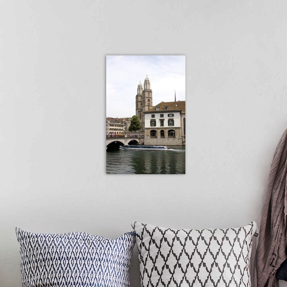 A bohemian room featuring Tour boat passes beneath Munster Bridge crossing the Limmat River in Zurich, Switzerland with tow...