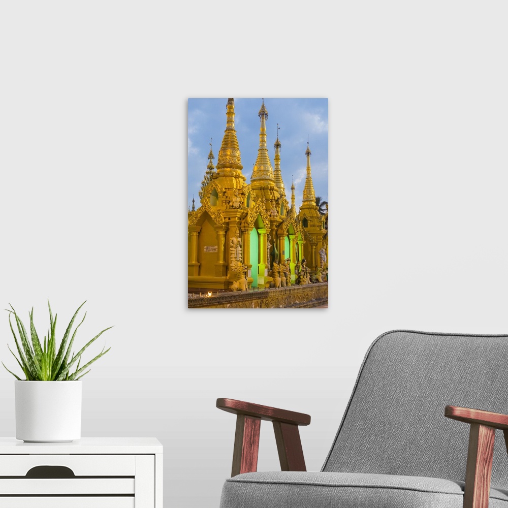A modern room featuring Myanmar. Yangon. Shwedagon Pagoda. Golden spires gleam at twilight.