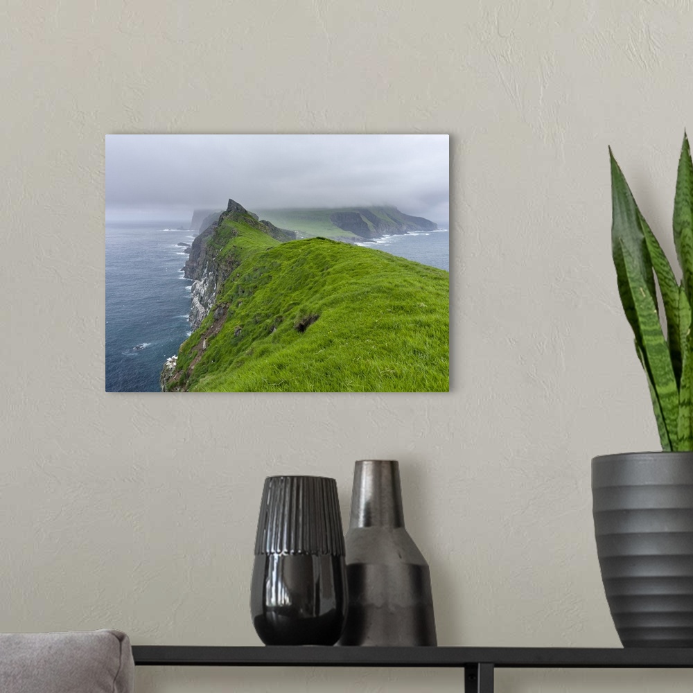 A modern room featuring The island Mykines, seen from Mykinesholmur, part of the Faroe Islands in the North Atlantic. Eur...