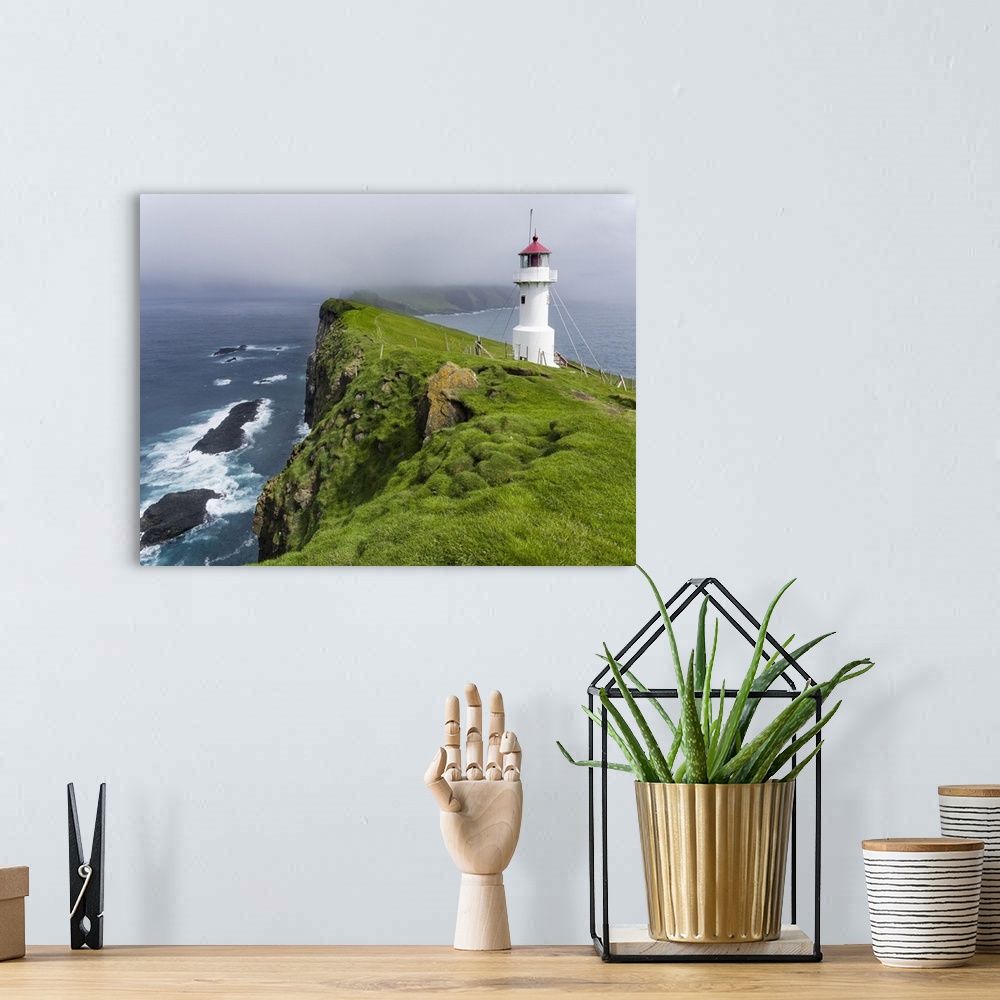 A bohemian room featuring The lighthouse on Mykinesholmur. The island Mykines, part of the Faroe Islands in the North Atlan...