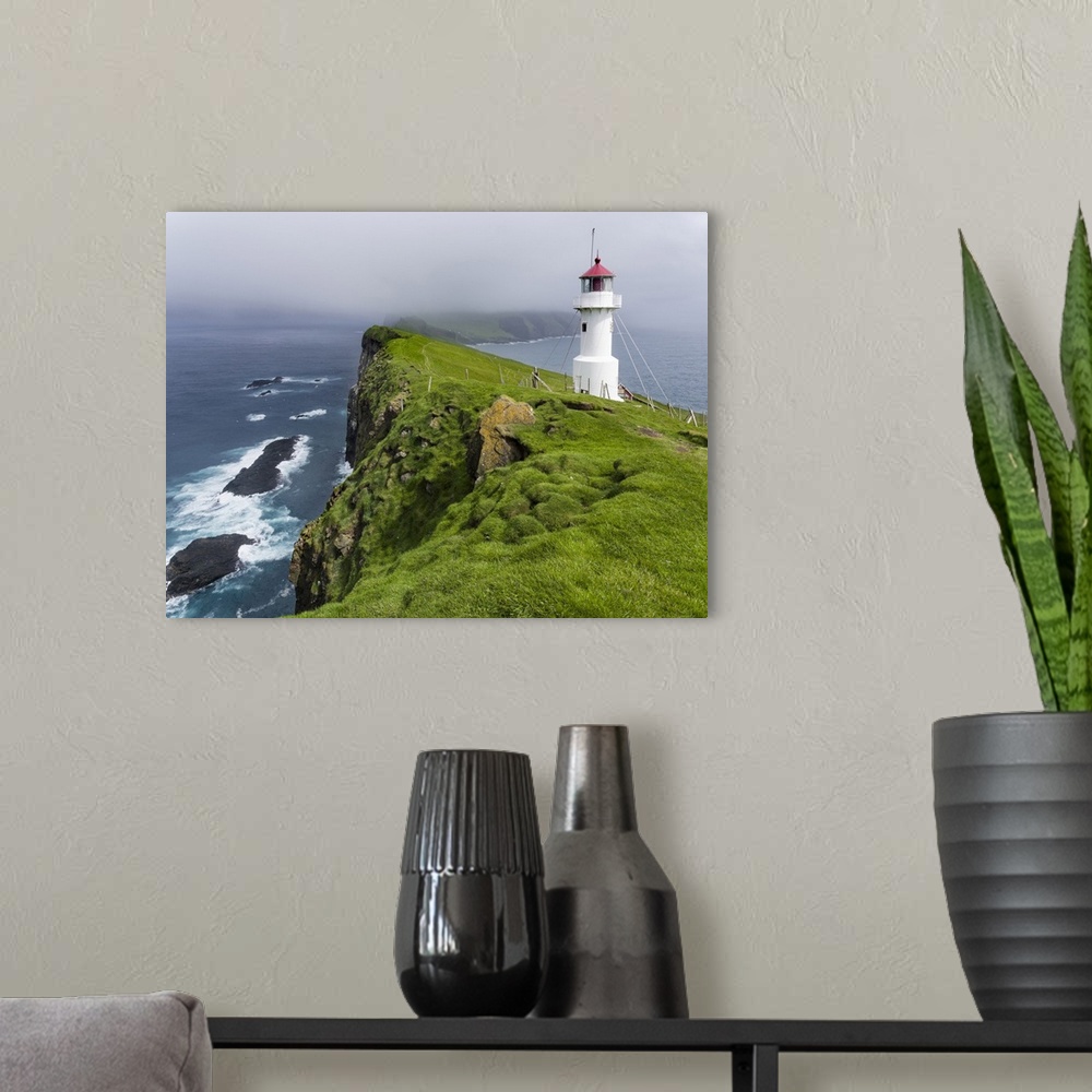 A modern room featuring The lighthouse on Mykinesholmur. The island Mykines, part of the Faroe Islands in the North Atlan...