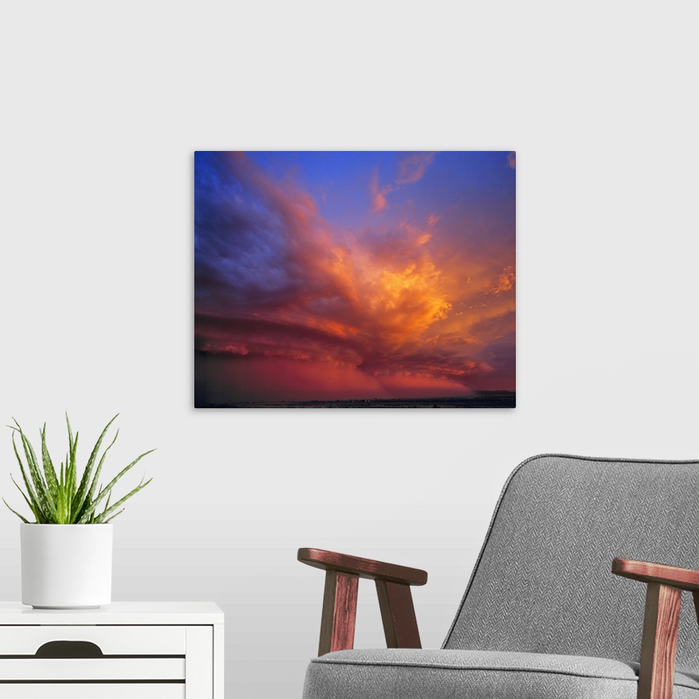 A modern room featuring USA, Nevada. Storm clouds color with the setting sun over the Nevada desert.