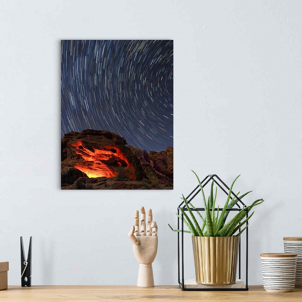 A bohemian room featuring Usa, Nevada. Valley of Fire State Park, star trails and campfire glowing in sandstone rocks.