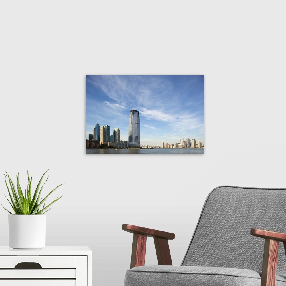 A modern room featuring USA, New Jersey, Jersey City, Manhattan skyline rises above Hudson River across from rising skysc...