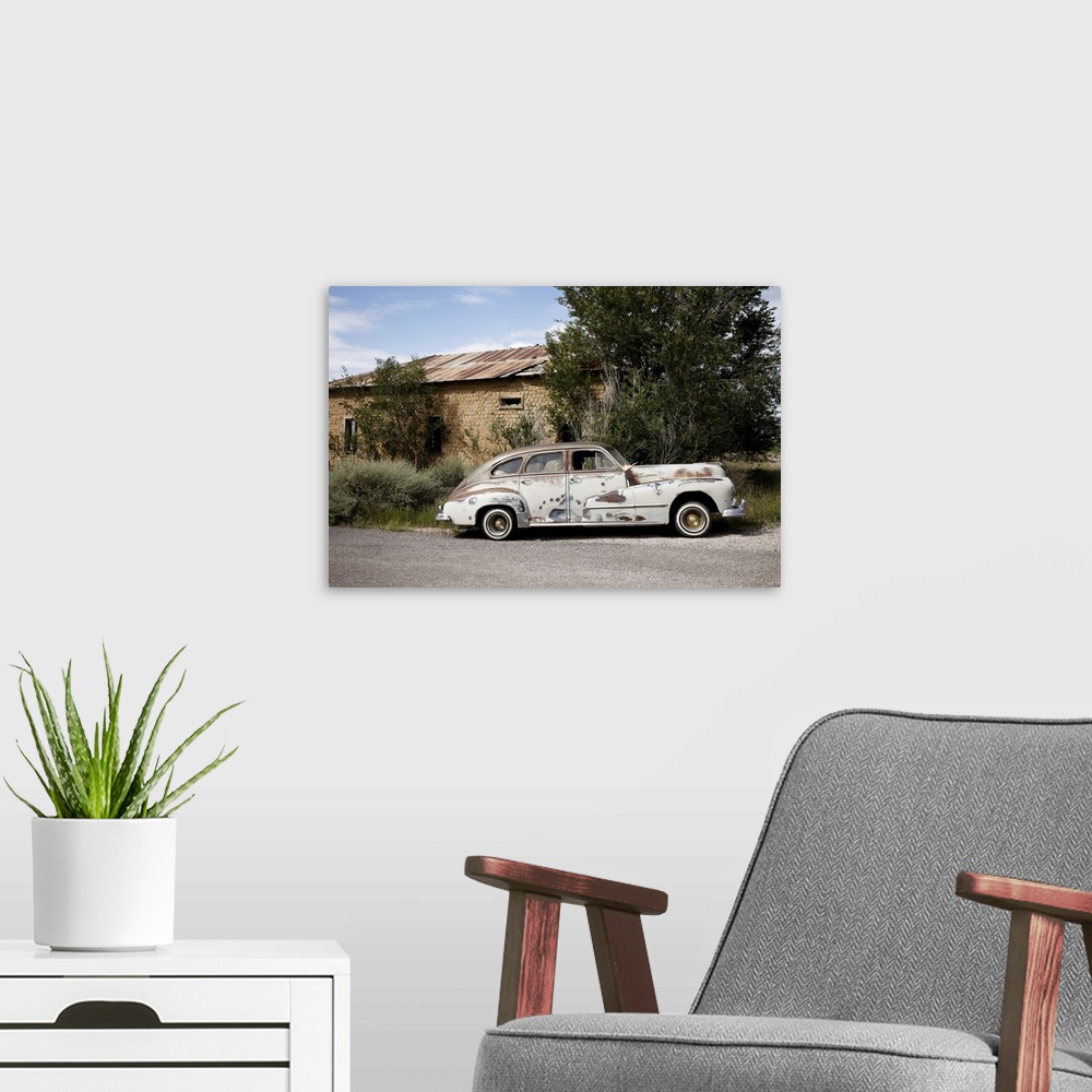 A modern room featuring Old worn classic car parked on the side of the road