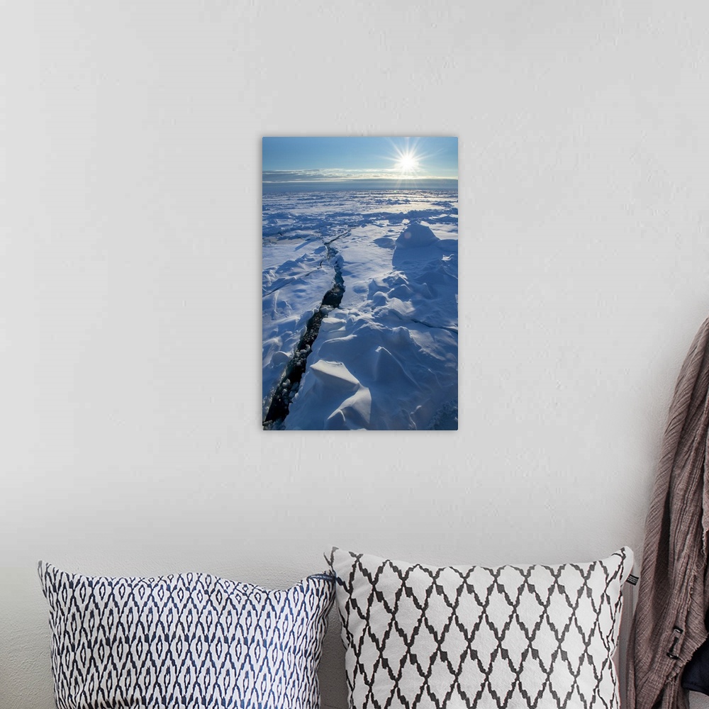 A bohemian room featuring Norway. Icescape at 84 degrees north, crack in ice with sunburst. Europe, Norway.
