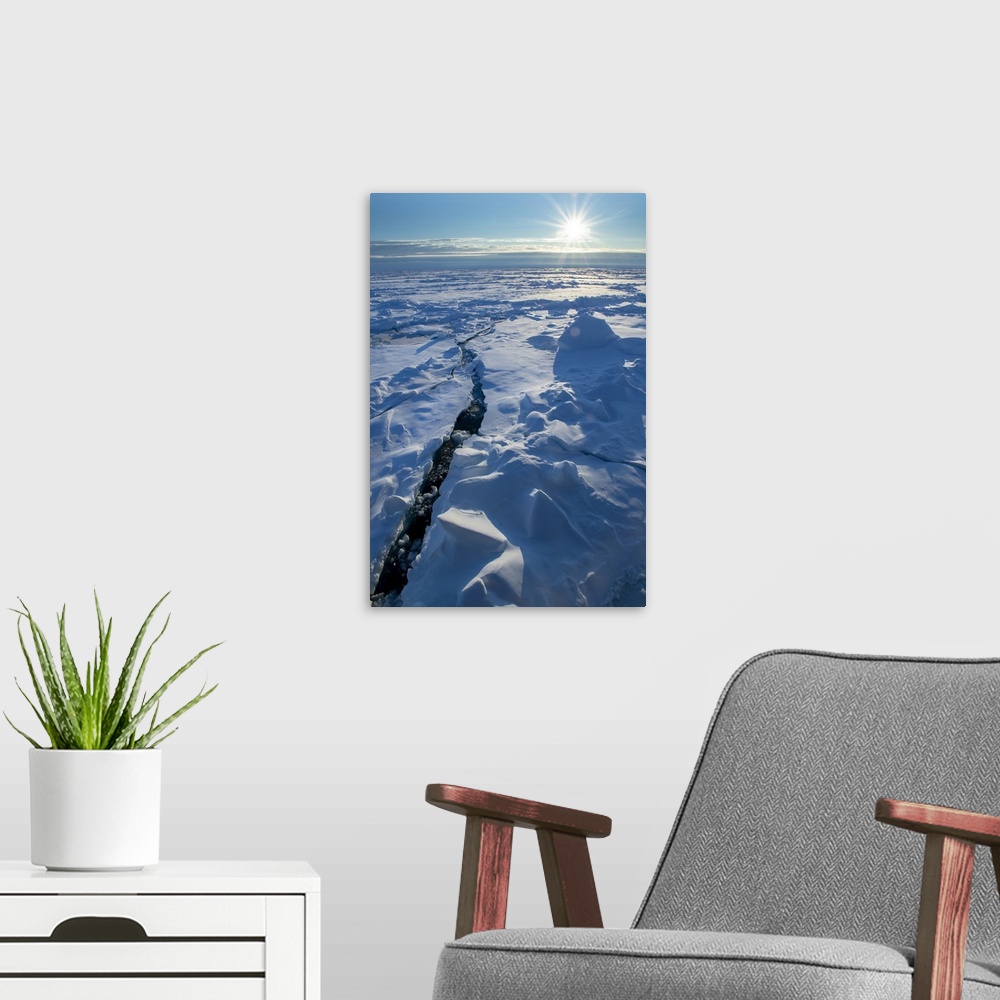 A modern room featuring Norway. Icescape at 84 degrees north, crack in ice with sunburst. Europe, Norway.