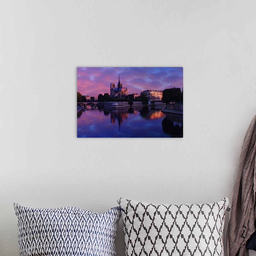A bohemian room featuring Notre Dame reflected on Seine River at sunrise, Paris, France