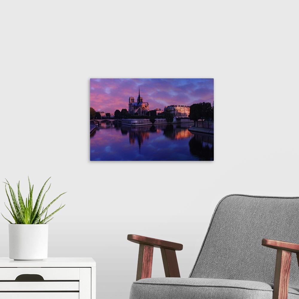 A modern room featuring Notre Dame reflected on Seine River at sunrise, Paris, France