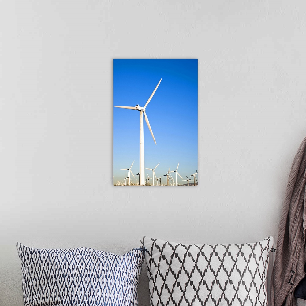 A bohemian room featuring Palm Springs, California. View of wind turbines in the desert under a clear blue sky.