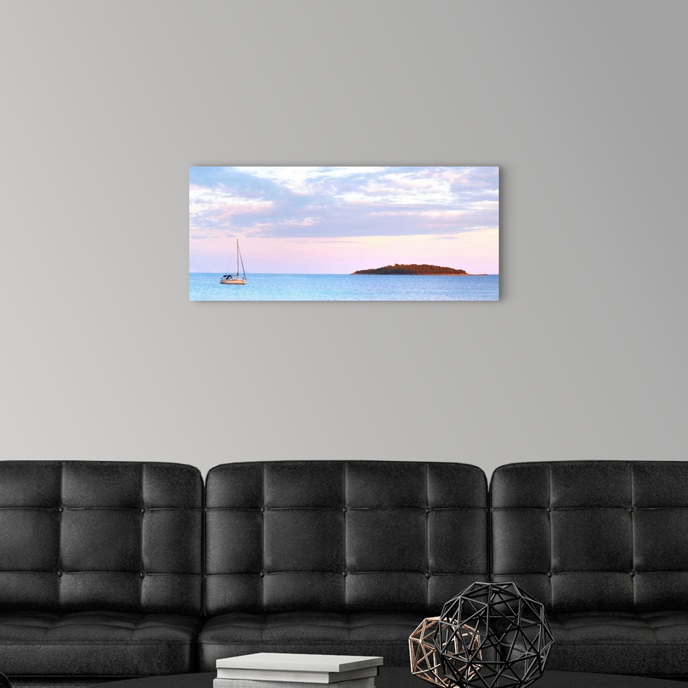 A modern room featuring Panorama of the bay a sailing boat moored in the bay island in the background, off the Korcula is...