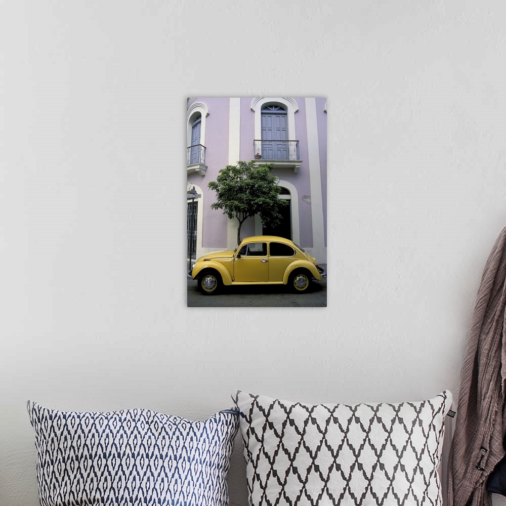 A bohemian room featuring Puerto Rico, Ponce, Historic District. 19th century pink and white house with yellow VW Beetle pa...